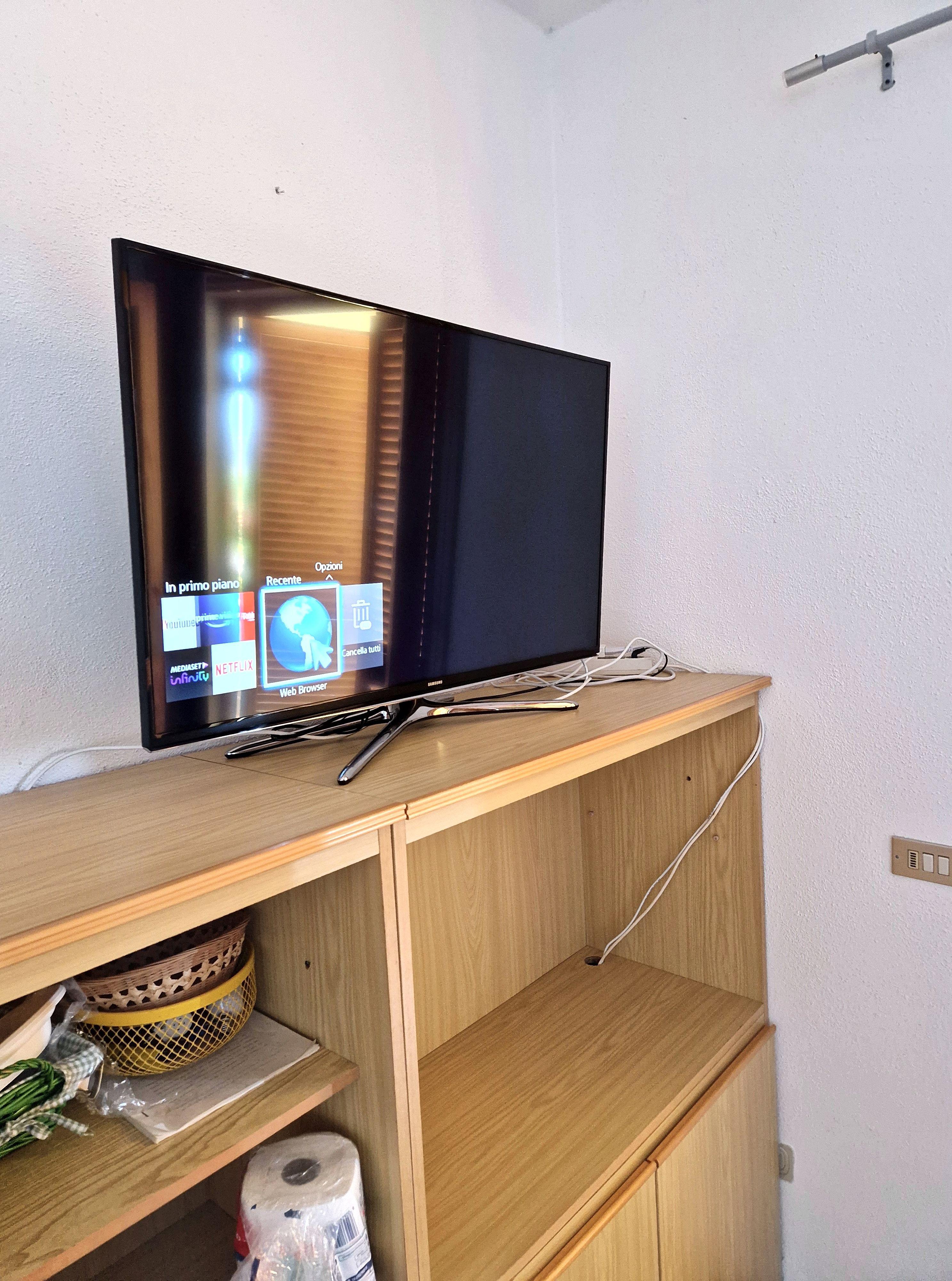 Area TV con mobile in legno e spazio di archiviazione